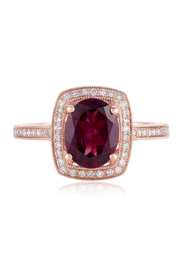 The Bordeaux 14K Rose Gold Rhodolite Garnet and Diamond Ring, 2.48 TCW showcases a large oval rhodolite garnet, double haloed by white diamonds, with additional diamond accents along the band.
