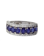 The Gemma White Gold Blue Sapphire & Diamond Ring, 2.61 TCW, features deep blue sapphires accented by sparkling diamonds in a curved white gold band, elegantly displayed against a white background.