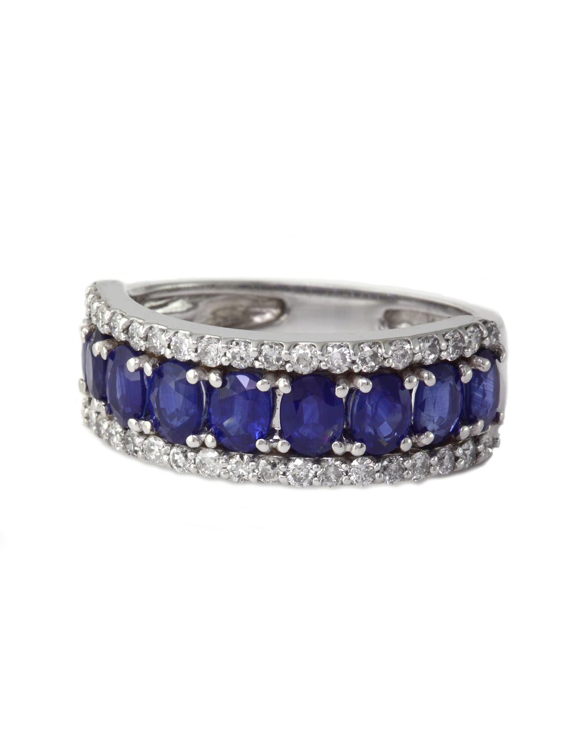 The Gemma White Gold Blue Sapphire & Diamond Ring, 2.61 TCW, features deep blue sapphires accented by sparkling diamonds in a curved white gold band, elegantly displayed against a white background.