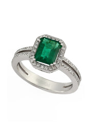 The Brasilica 14K White Gold Emerald and Diamond Ring, 1.70 TCW, features a rectangular green emerald centerpiece framed by diamonds and a split shank band adorned with dazzling diamonds.