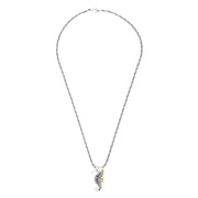 The Seaside Sterling Silver Sapphire and Diamond Seahorse Pendant features gold-accented fins and head, a sapphire gemstone eye, diamond details, and an elegant twisted chain design.