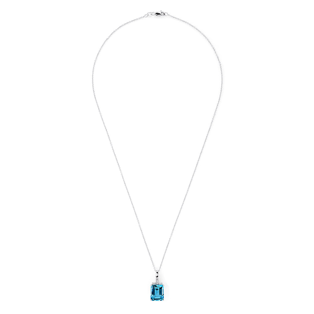 A 14K white gold pendant featuring an 8.48 TCW rectangular blue topaz and sparkling diamond accents on the bail, capturing the brilliance of a classic diamond pendant.