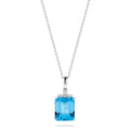 A 14K white gold pendant featuring an 8.48 TCW rectangular blue topaz and sparkling diamond accents on the bail, capturing the brilliance of a classic diamond pendant.