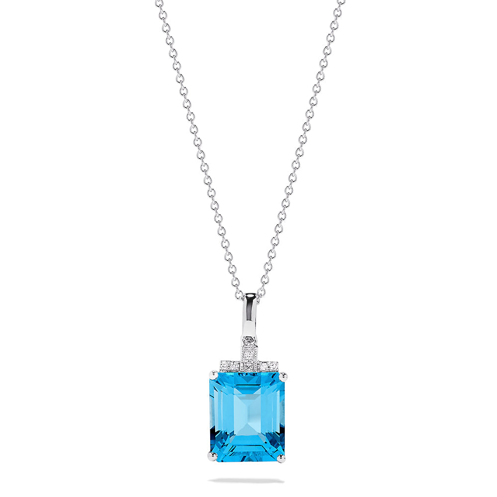A 14K white gold pendant featuring an 8.48 TCW rectangular blue topaz and sparkling diamond accents on the bail, capturing the brilliance of a classic diamond pendant.
