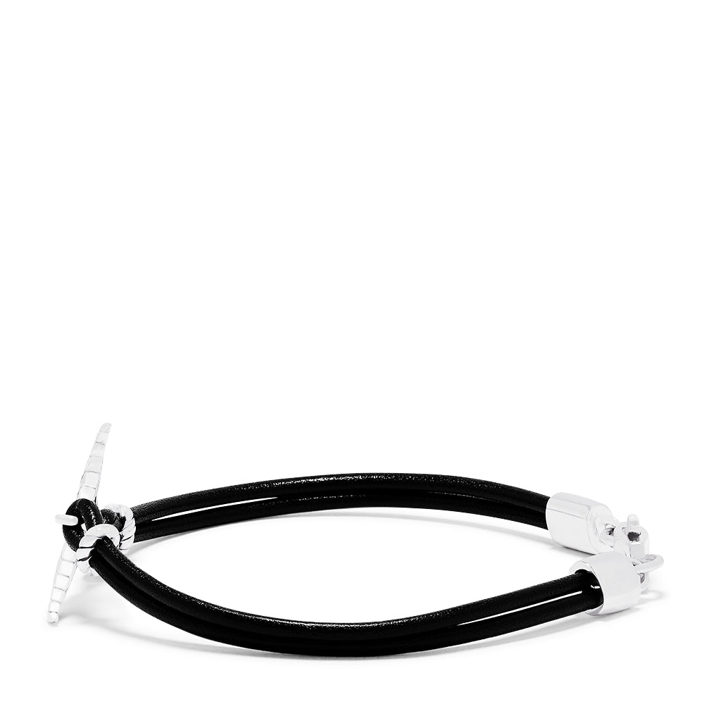 The Mens Sterling Silver and Leather Whales Tail Bracelet features a black leather cord, a polished silver whale tail charm at the center, and silver clasps, displayed on a white background.