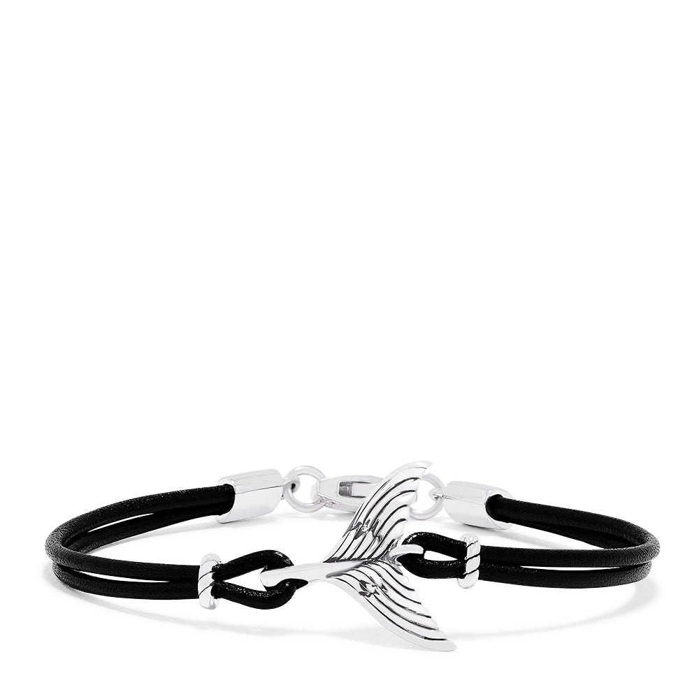 The Mens Sterling Silver and Leather Whales Tail Bracelet features a black leather cord, a polished silver whale tail charm at the center, and silver clasps, displayed on a white background.