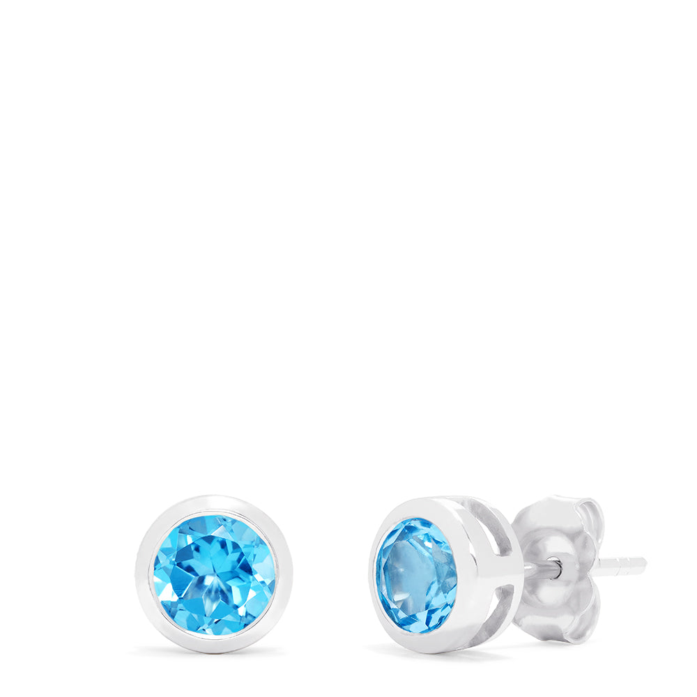 Ocean Bleu 14K White Gold Blue Topaz Stud Earrings, 1.10 TCW, feature brilliant round blue gemstones in sleek white gold bezels and are shown on a white background.
