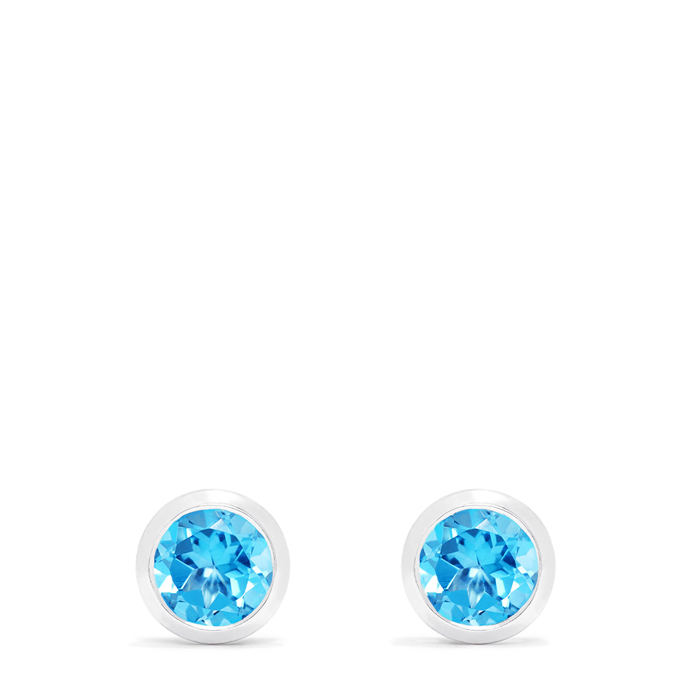 Ocean Bleu 14K White Gold Blue Topaz Stud Earrings, 1.10 TCW, feature brilliant round blue gemstones in sleek white gold bezels and are shown on a white background.