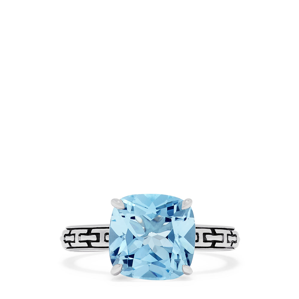 The 925 Sterling Silver Blue Topaz Ring, 5.20 TCW, features a square-cut light blue gemstone and geometric black engravings along the band, offering a modern and elegant style.