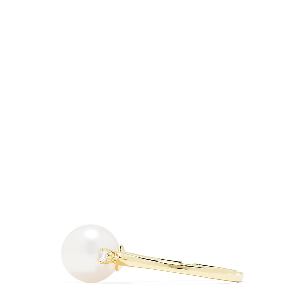The 14K Yellow Gold Cultured Pearl and Diamond Accented Ring, 0.05 TCW, features a large round cultured pearl at the center with diamond accents on each side, shown on a plain white background.