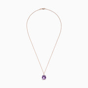 The 14K Rose Gold Amethyst and Diamond Pendant, 6.62 TCW, features a cushion-cut amethyst with diamond accents in a four-prong setting and is elegantly displayed on a white background.