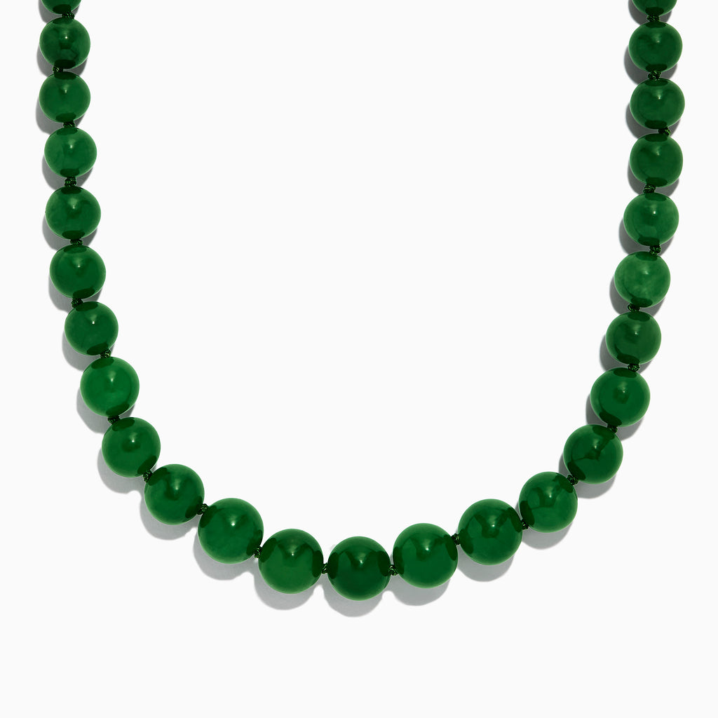 A close-up of a 14K Yellow Gold Jade Necklace, 339.00 TW, arranged in a curved shape against a white background.