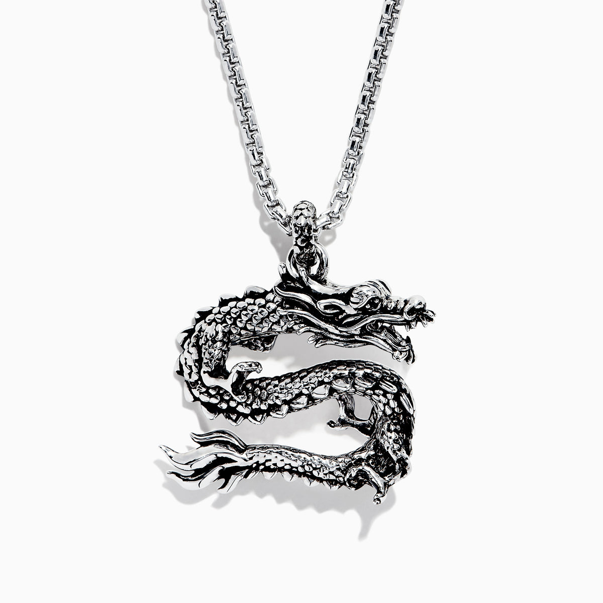 The Mens Sterling Silver Dragon Pendant features an intricately detailed dragon with textured scales, suspended from a box-link chain—a bold and captivating statement piece.