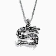 The Mens Sterling Silver Dragon Pendant features an intricately detailed dragon with textured scales, suspended from a box-link chain—a bold and captivating statement piece.