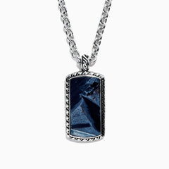 The Mens Sterling Silver Pietersite Dog Tag Pendant, 9.50 TCW, features a rectangular dog tag with a dark blue marbled pietersite stone set in an ornate silver frame on a sterling silver chain.