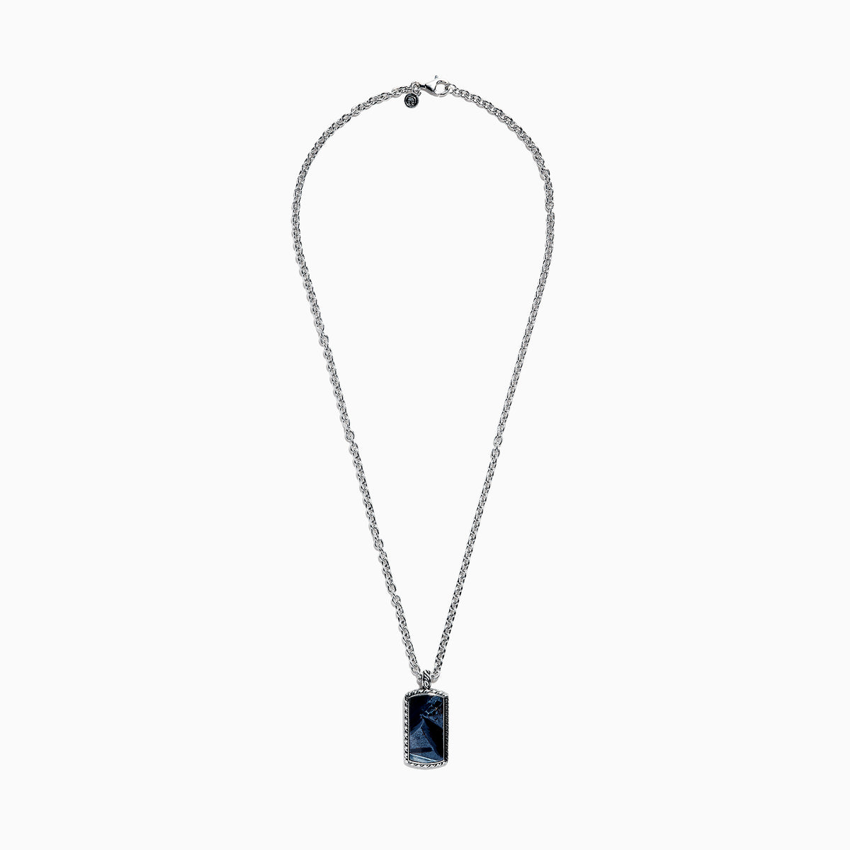 The Mens Sterling Silver Pietersite Dog Tag Pendant, 9.50 TCW, features a rectangular dog tag with a dark blue marbled pietersite stone set in an ornate silver frame on a sterling silver chain.