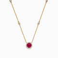 The Ruby Royale 14K Yellow Gold Ruby and Diamond Station Necklace, 1.11 TCW, features a round ruby pendant surrounded by diamonds and additional diamond accents spaced along the chain.
