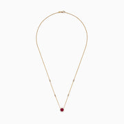 The Ruby Royale 14K Yellow Gold Ruby and Diamond Station Necklace, 1.11 TCW, features a round ruby pendant surrounded by diamonds and additional diamond accents spaced along the chain.