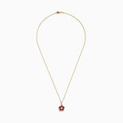 The Ruby Royale 14K Yellow Gold Ruby and Diamond Flower Pendant, 1.43 TCW, features a delicate gold chain with a flower-shaped pendant adorned with ruby gemstones and a central diamond, shown on a plain white background.