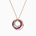 The Ruby Royale 14K Rose Gold Pendant showcases three interlocking ruby and diamond circles (0.66 TCW) on a delicate chain, set against a white background.
