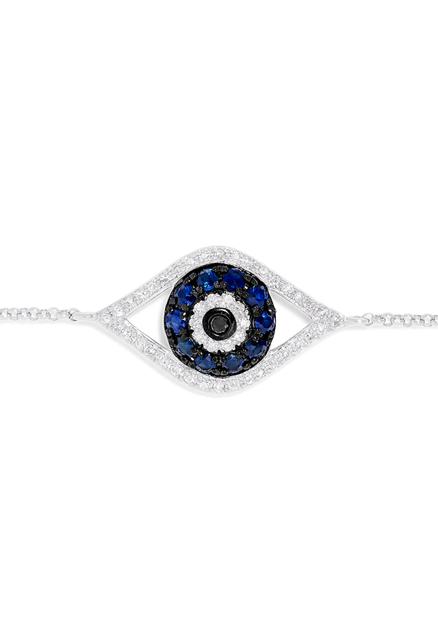 The Novelty 14K White Gold Sapphire & Diamond Evil Eye Bracelet, 0.43 TCW, features a central eye charm set with blue sapphires and diamonds on a fine chain with lobster clasp. Shown on a plain white background.