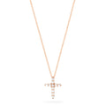 A Pave Rose 14K Gold Diamond Cross Pendant (0.22 TCW) hangs on a fine gold chain, adorned with sparkling diamonds. Shown on a plain white background.