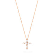 A Pave Rose 14K Gold Diamond Cross Pendant (0.22 TCW) hangs on a fine gold chain, adorned with sparkling diamonds. Shown on a plain white background.