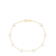 The 14K Yellow Gold Cultured Fresh Water Pearl Station Bracelet features evenly spaced pearls on a delicate gold chain with a small round clasp, shown against a white background.