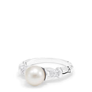 The 925 Sterling Silver Cultured Pearl and Diamond Ring (0.03 TCW) features a round pearl at the center with two small square-set diamonds on each side, displayed against a plain white background.
