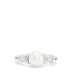The 925 Sterling Silver Cultured Pearl and Diamond Ring (0.03 TCW) features a round pearl at the center with two small square-set diamonds on each side, displayed against a plain white background.