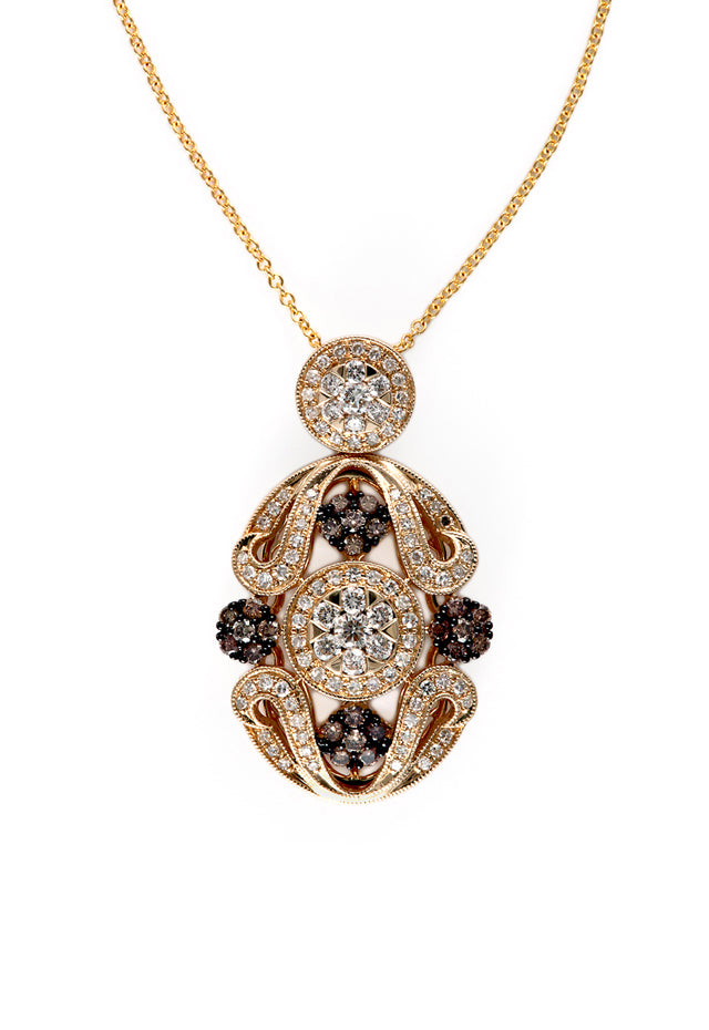 The 14K Yellow Gold Diamond Filigree Pendant features ornate scrollwork with white and dark diamonds totaling 1.04 TCW, all set in luminous yellow gold against a white background.