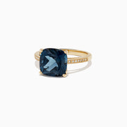 The Ocean Bleu 14K yellow gold ring boasts a cushion-cut London Blue Topaz centerpiece and sparkling round diamonds along the band, totaling 4.54 TCW.
