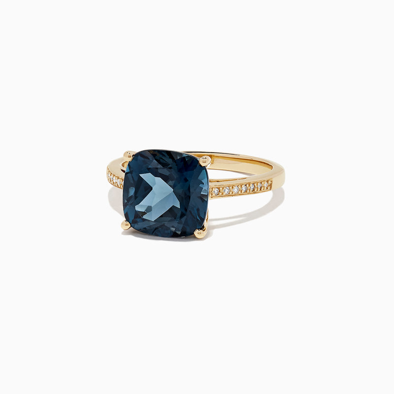 The Ocean Bleu 14K yellow gold ring boasts a cushion-cut London Blue Topaz centerpiece and sparkling round diamonds along the band, totaling 4.54 TCW.
