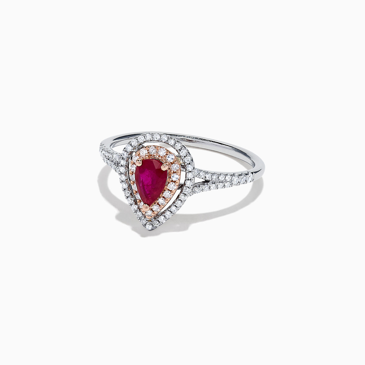 The Ruby Royale 14K Two Tone Gold Ring features a pear-shaped ruby at the center, surrounded by two halos of sparkling diamonds (0.77 TCW), elegantly set and displayed on a plain white background.