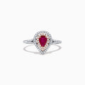 The Ruby Royale 14K Two Tone Gold Ring features a pear-shaped ruby at the center, surrounded by two halos of sparkling diamonds (0.77 TCW), elegantly set and displayed on a plain white background.