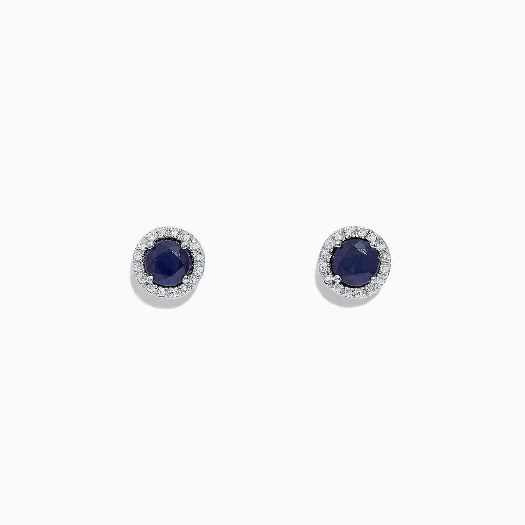 The Royale Bleu 14K White Gold Sapphire & Diamond Stud Earrings, 1.27 TCW, feature deep blue round sapphires encircled by a halo of diamonds and are shown on a white background.