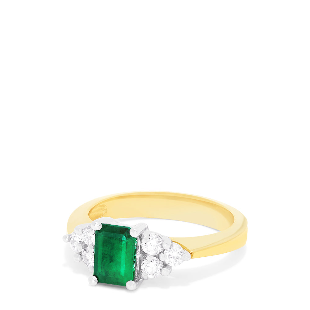 The Brasilica 14K 2-Tone Gold Emerald and Diamond Ring (1.36 TCW) features a rectangular green emerald center, accented by three round white diamonds on each side in a symmetrical design.