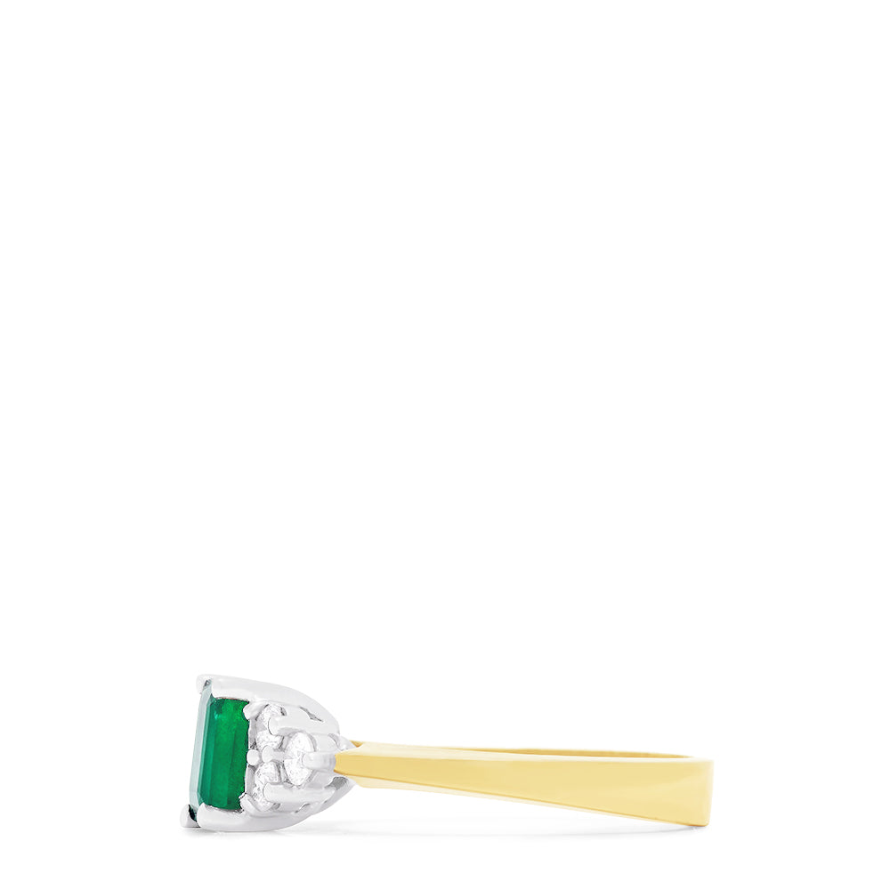 The Brasilica 14K 2-Tone Gold Emerald and Diamond Ring (1.36 TCW) features a rectangular green emerald center, accented by three round white diamonds on each side in a symmetrical design.