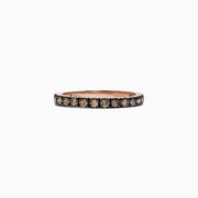 The 14K Rose Gold Brown Diamond Stacking Ring, 0.65 TCW, showcases a full circle of round brown diamonds in a channel setting, perfect for stacking and shown against a white backdrop.