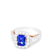 The Nahla Siri 14K Two Tone Gold Emerald Cut Tanzanite and Diamond Ring, 2.32 TCW, showcases a halo of round white diamonds on a diamond-encrusted band, set against a white background.