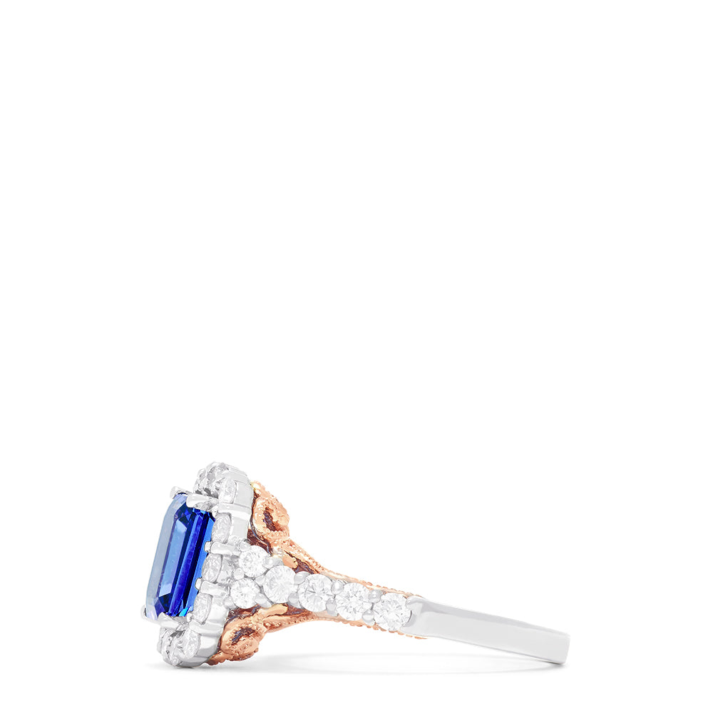 The Nahla Siri 14K Two Tone Gold Emerald Cut Tanzanite and Diamond Ring, 2.32 TCW, showcases a halo of round white diamonds on a diamond-encrusted band, set against a white background.