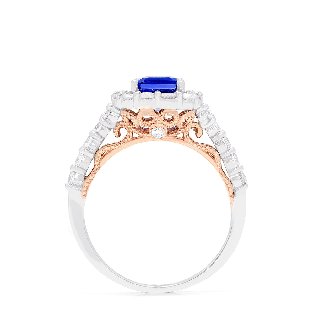 The Nahla Siri 14K Two Tone Gold Emerald Cut Tanzanite and Diamond Ring, 2.32 TCW, showcases a halo of round white diamonds on a diamond-encrusted band, set against a white background.