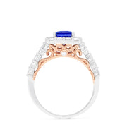 The Nahla Siri 14K Two Tone Gold Emerald Cut Tanzanite and Diamond Ring, 2.32 TCW, showcases a halo of round white diamonds on a diamond-encrusted band, set against a white background.