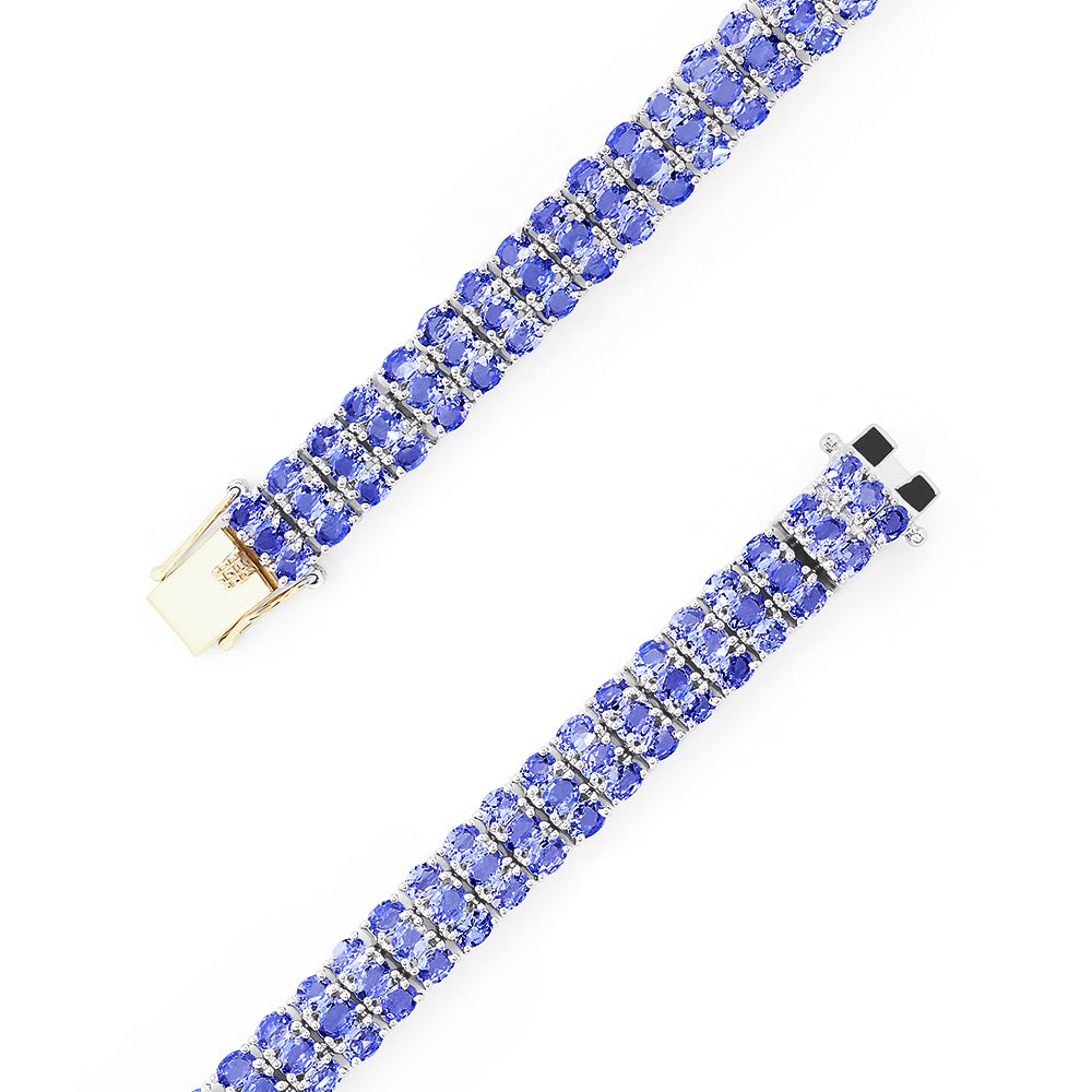 The Sterling Silver with 14K Yellow Gold Lock Tanzanite Bracelet, 20.00 TCW, features three rows of alternating blue and clear gemstones and a rectangular silver and 14K yellow gold clasp at the center.