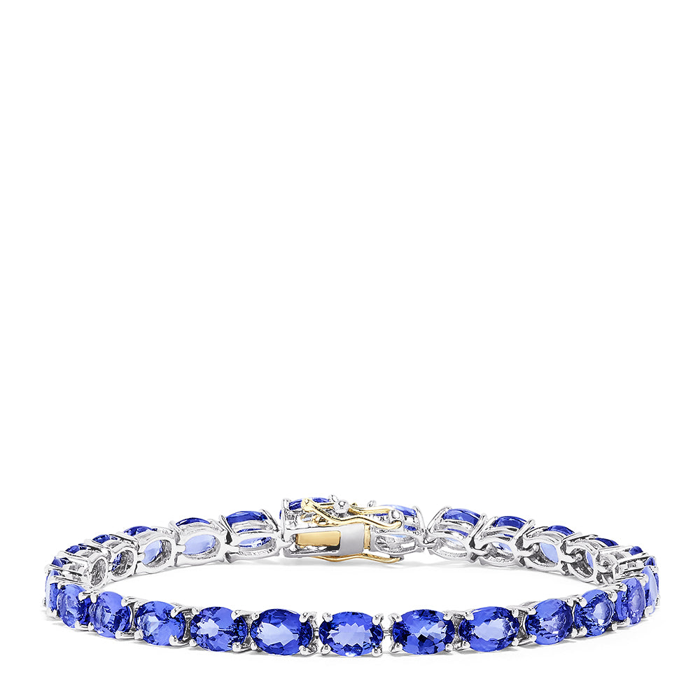 The Sterling Silver with 14K Gold Lock Tanzanite Tennis Bracelet, 20.00 TCW, features a row of sparkling tanzanites and a gold-accented clasp, beautifully displayed against a white background.