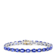The Sterling Silver with 14K Gold Lock Tanzanite Tennis Bracelet, 20.00 TCW, features a row of sparkling tanzanites and a gold-accented clasp, beautifully displayed against a white background.