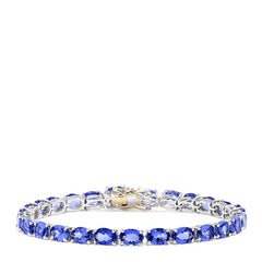 The Sterling Silver with 14K Gold Lock Tanzanite Tennis Bracelet, 20.00 TCW, features a row of sparkling tanzanites and a gold-accented clasp, beautifully displayed against a white background.