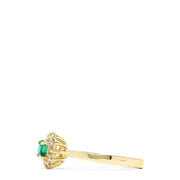The 14K Yellow Gold Emerald and Diamond Ring, 0.36 TCW, showcases a round emerald center accented by a floral halo of sparkling white diamonds.