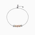 The Seaside 14K Tri Color Gold Diamond Starfish Bracelet features five diamond-encrusted starfish charms in silver, gold, and rose gold tones, arranged symmetrically along an adjustable chain. Total carat weight: 0.28 TCW.