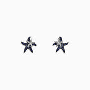 The Seaside 14K White Gold Sapphire & Diamond Starfish Stud Earrings (0.71 TCW) feature blue sapphires and diamonds in a starfish design, shown against a plain white background.